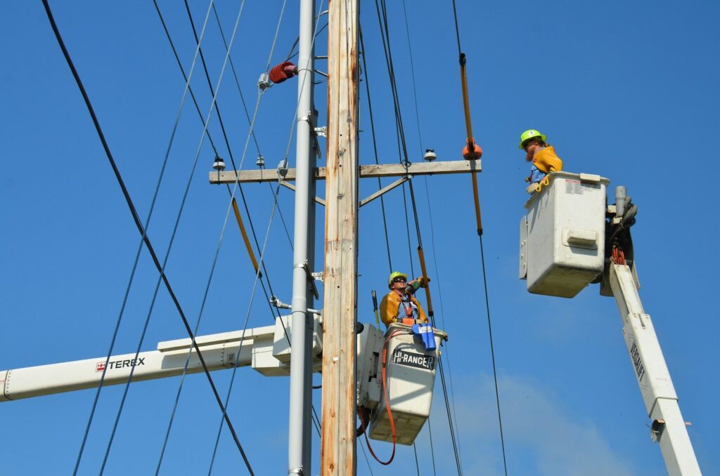 two linemen on cherry pickers