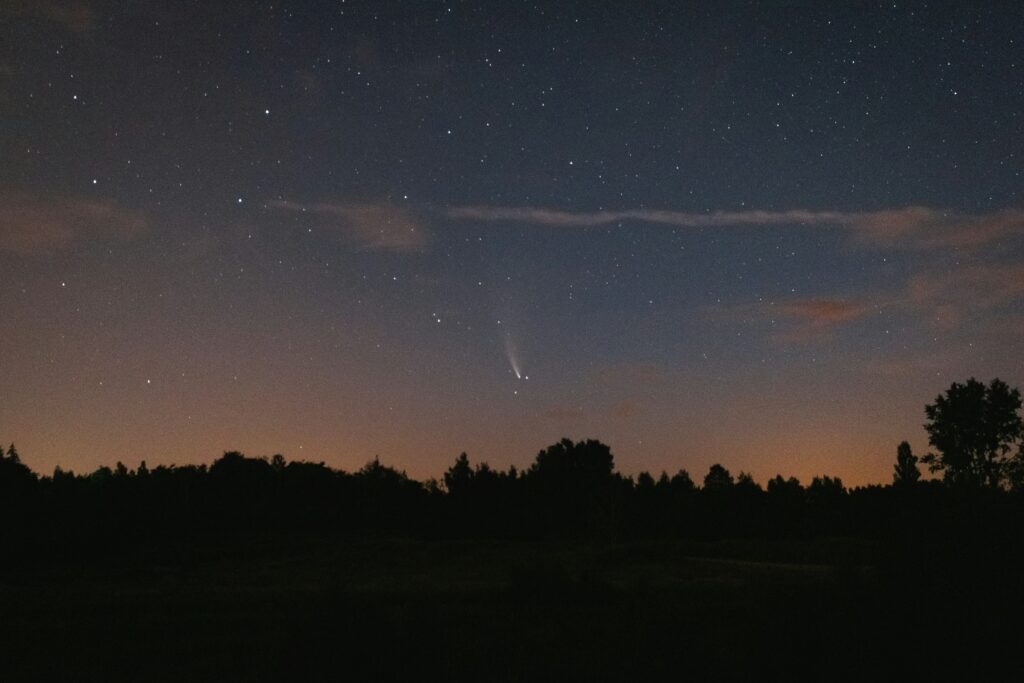Meteors streaking across a dark, starry night sky
