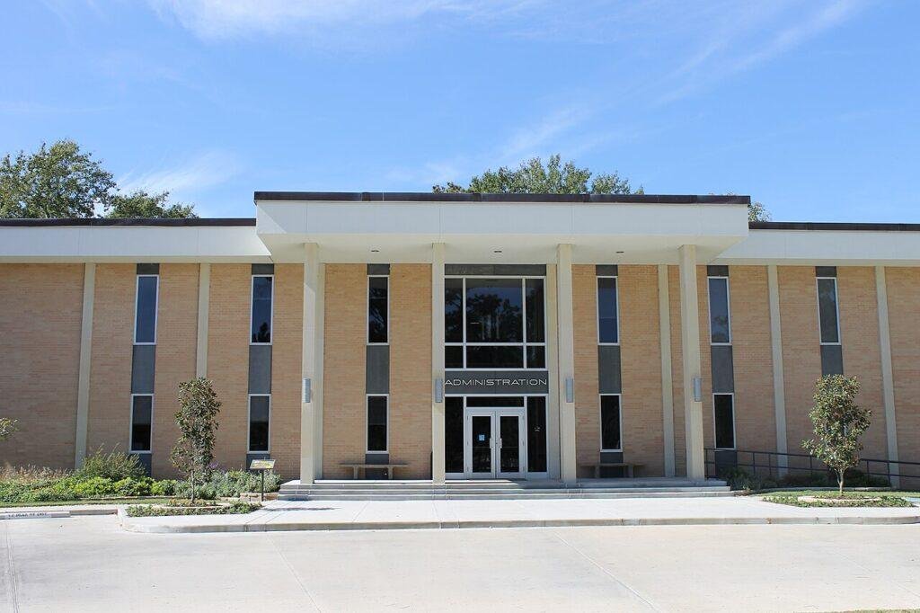 Angelina College administration building in Lufkin under a clear blue sky