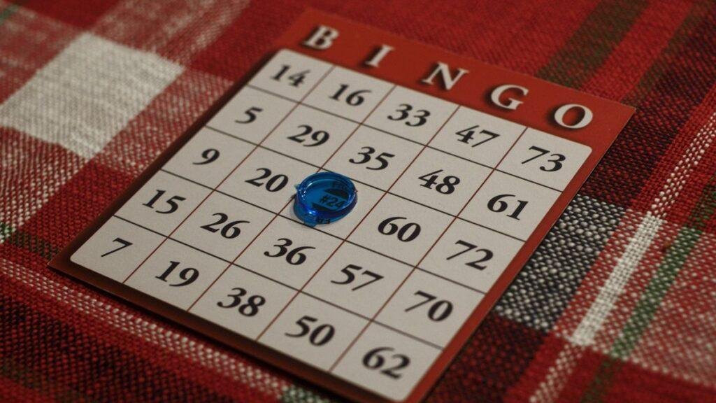 Bingo card and marker on a plaid tablecloth