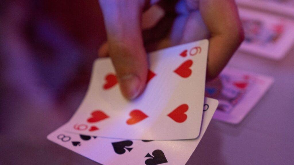 A hand of playing cards fanned out on a table