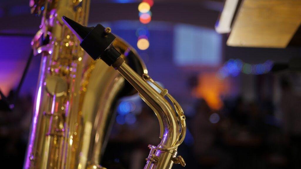 A saxophone on stage under warm venue lighting