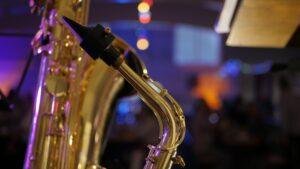 A saxophone on stage under warm venue lighting