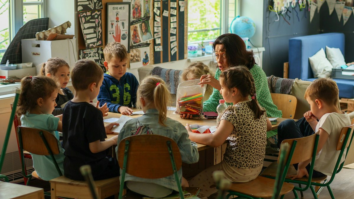 Children working on a craft project at a classroom table