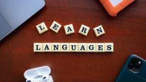 Letter tiles spelling LEARN LANGUAGES on a desk
