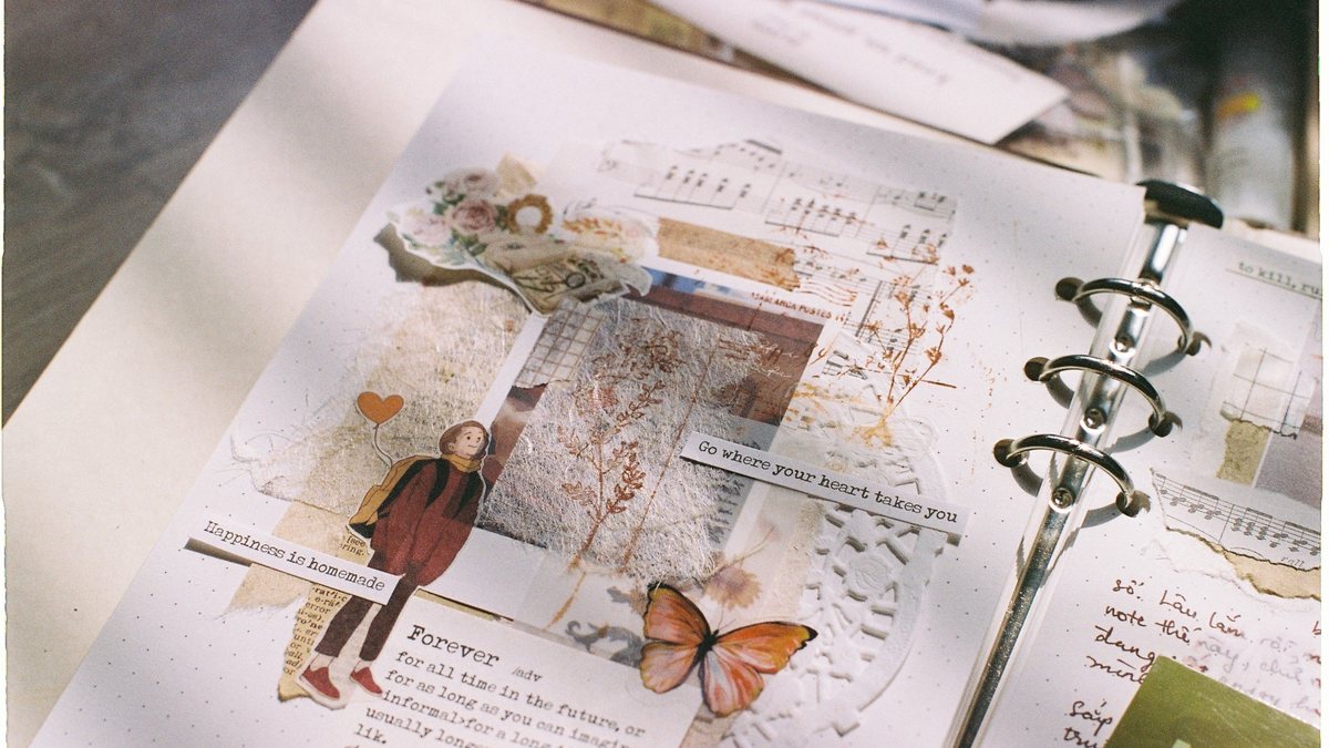 An open scrapbook page with pasted clippings and photos