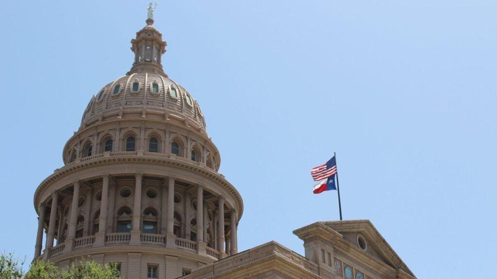 Dome of the Texas State Capitol with the United States flag