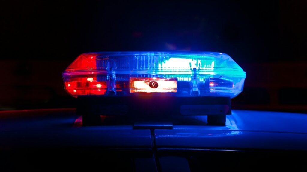A police light bar flashing red and blue at night