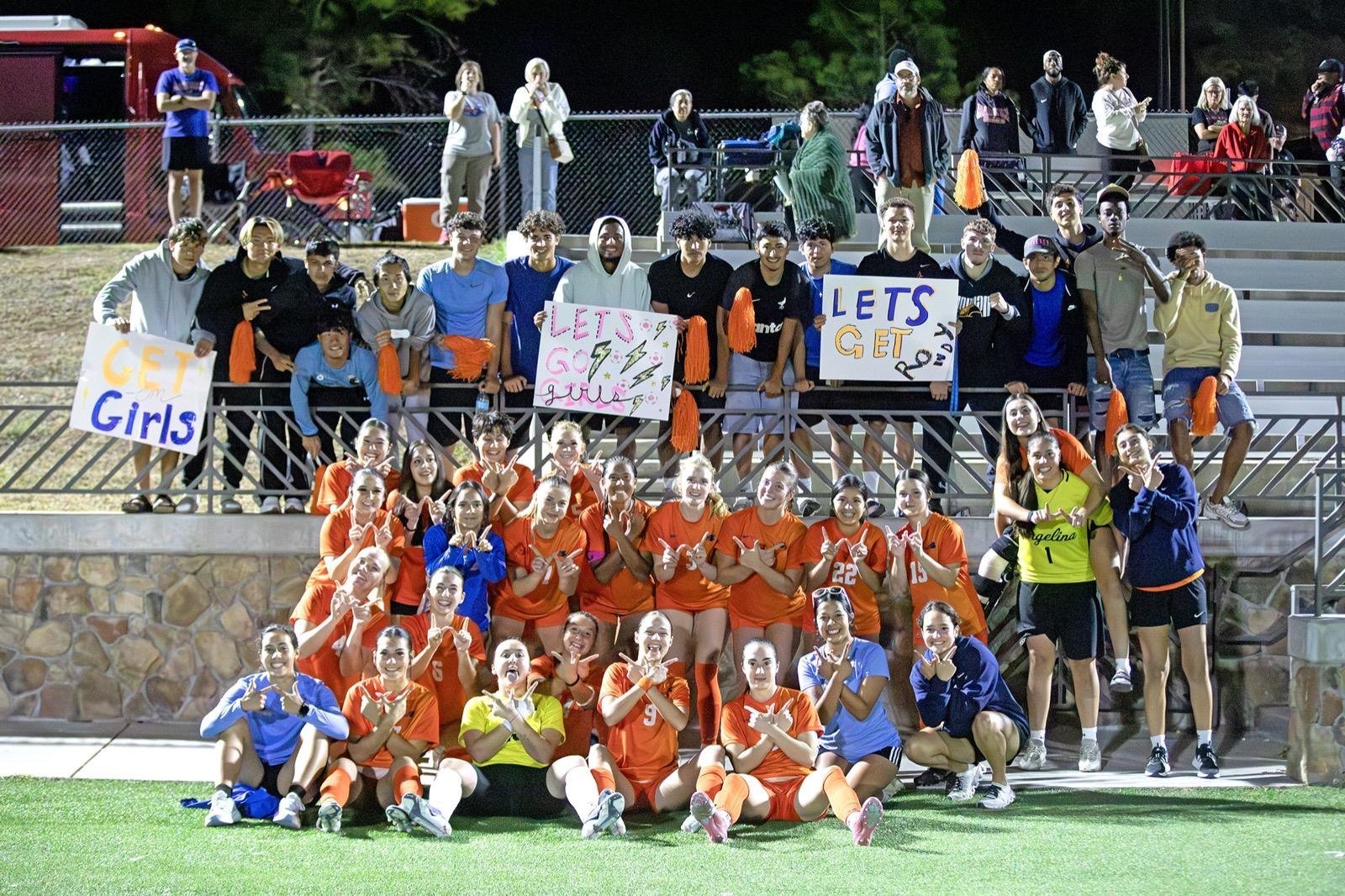 Angelina College soccer fans rush onto the pitch to celebrate with the Lady Roadrunners after the Region XIV quarterfinal upset of No. 13 Navarro College.
