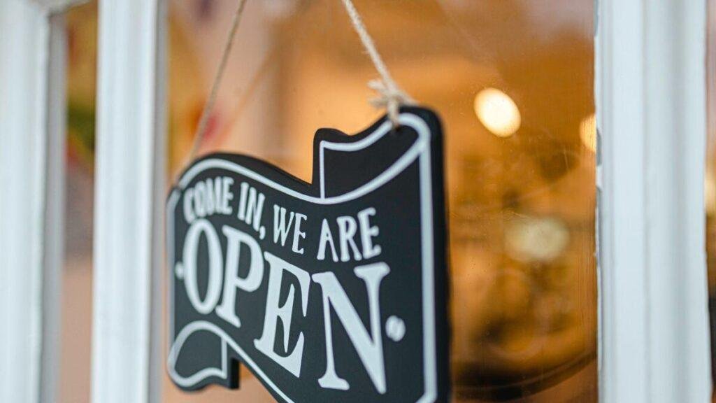 Come in we are open sign hanging on a shop door