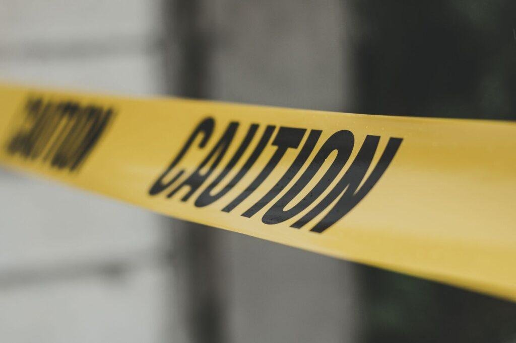 Close-up of yellow caution tape with a blurred background
