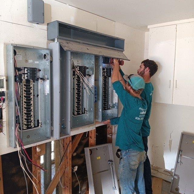 Piney Woods Electric electrician working on a panel install
